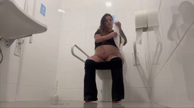 Pregnant woman using a public restroom